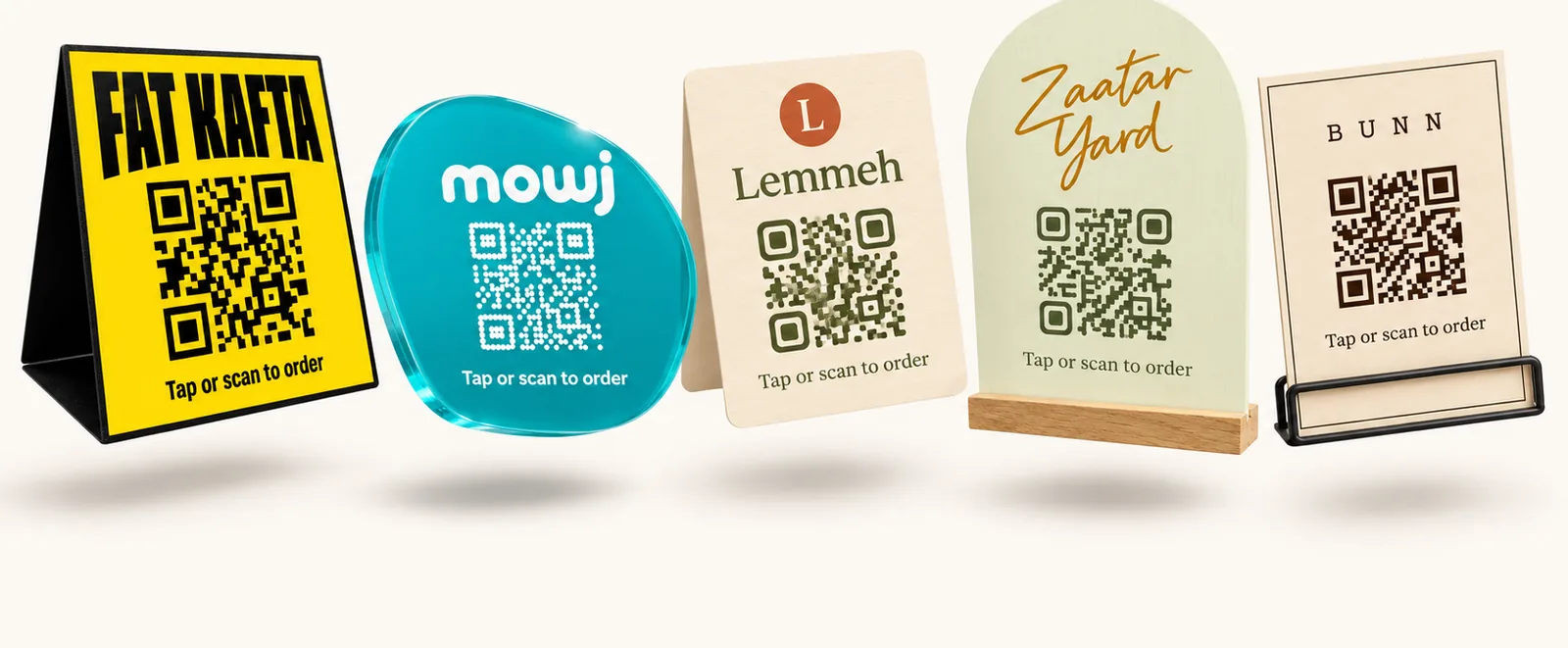 Five table cards with QR codes, one for each venue, each in its own colours and shape.